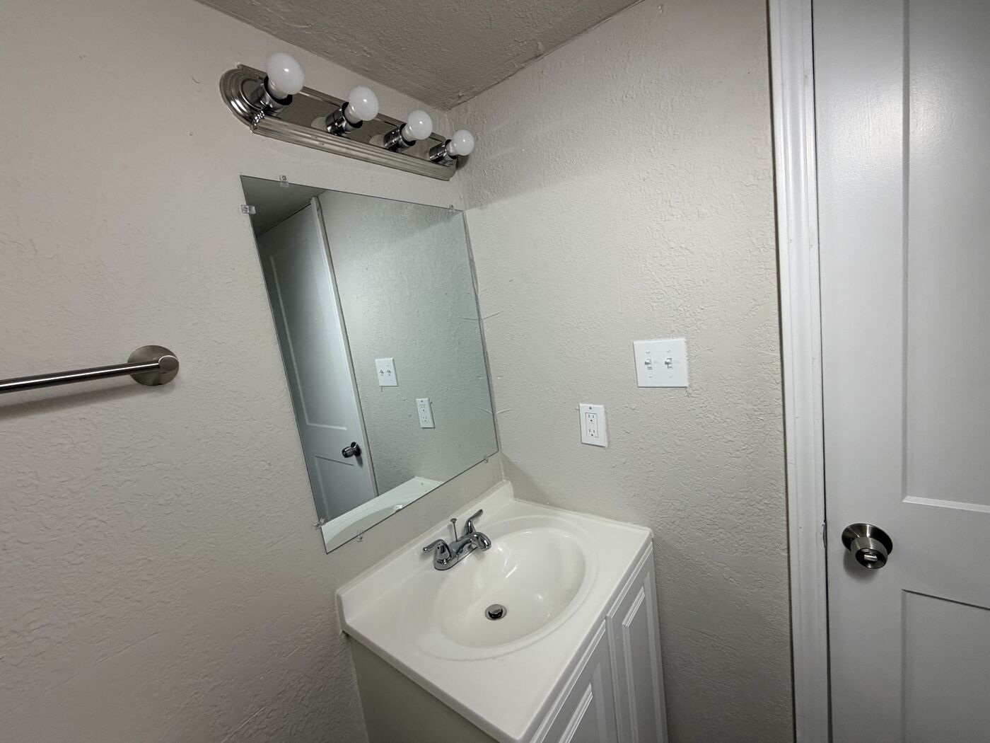 1-bedroom apartment bathroom vanity and mirror